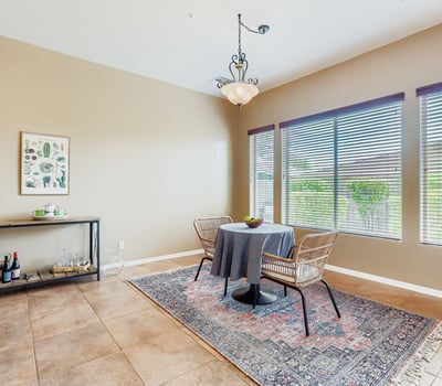 A light-filled breakfast nook offers views of the landscaped backyard, creating the perfect spot for everyday dining.