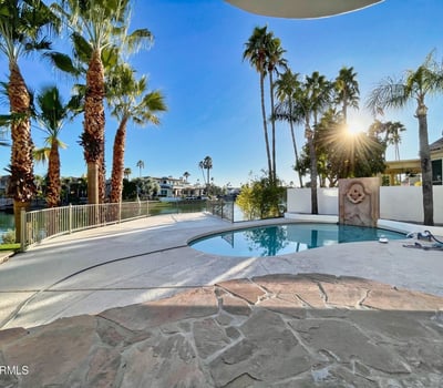 Breathtaking lakefront view lined with palms and lush landscaping. A serene Scottsdale escape designed for peace and beauty.