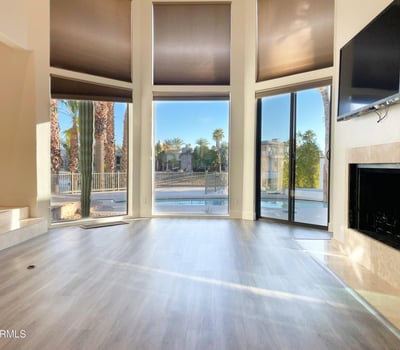 Modern fireplace surrounded by expansive windows and tranquil lake views. A peaceful retreat for both comfort and style.