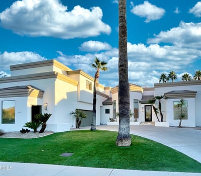Modern white fa ade accented with desert greenery and bold rooflines. A perfect fusion of clean design and timeless elegance.