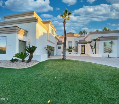 Eye-catching architectural design featuring pristine white exterior, tiered rooflines, and lush greenery for stunning curb appeal.