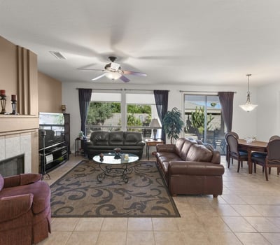 Expansive windows brighten this inviting living space, highlighting the seamless connection to the private backyard and showcasing the best of Arizona indoor-outdoor living.