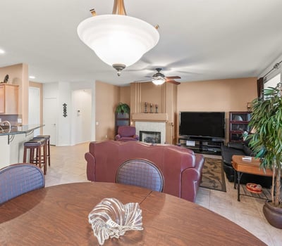 A beautiful dining area opens effortlessly to the living room and kitchen. Elegant lighting and tile floors enhance its bright, open ambiance.