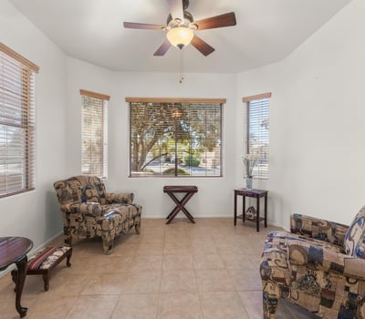 Relax in this cheerful breakfast nook surrounded by windows and natural light. A comfortable, airy space ideal for casual dining or reading.