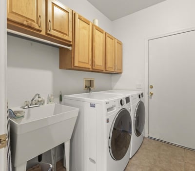 Practical utility area with wash basin, upper storage, and workspace designed to simplify cleaning and maintenance tasks.