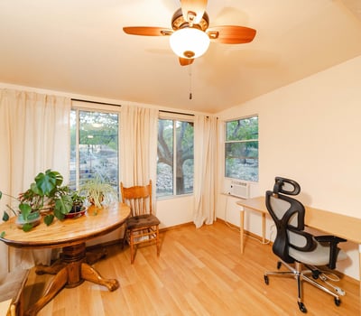 This airy flex space offers panoramic window views and bright natural light, ideal for remote work, plant lovers, or creative pursuits. Warm flooring and peaceful desert scenery enhance everyday comfort.