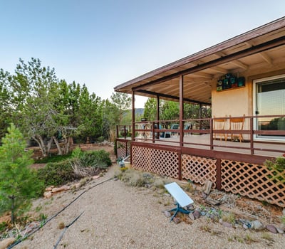 Relax beneath the covered deck surrounded by mature trees and calming mountain breezes. The outdoor design encourages peaceful living in Hackberry s tranquil landscape.
