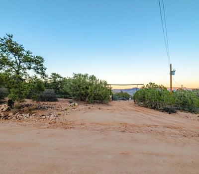 This soft-slope entry road highlights the land s natural beauty, blending mature shrubs, rolling terrain, and clear skies. Ideal for those drawn to wide-open spaces and outdoor living potential.