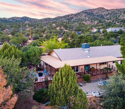 This image captures the home nestled into the surrounding desert pines, offering scenic views and outdoor tranquility. Ideal for buyers seeking a nature-focused lifestyle in Hackberry.