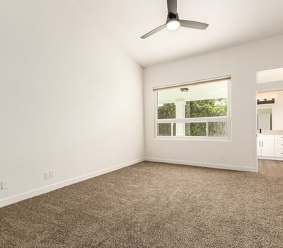 Spacious primary bedroom with high ceilings, plush carpet, and generous natural light. The peaceful Scottsdale setting offers a relaxing retreat with easy access to the updated ensuite bathroom.