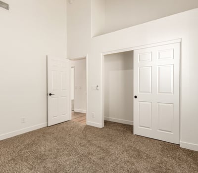 Bright guest bedroom with neutral finishes and soft carpeting. This Scottsdale room offers flexible use as a bedroom, home office, or hobby space.
