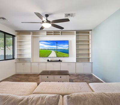 Open great room with tile floors and ceiling fan, seamlessly connecting the main living areas for comfortable daily living.