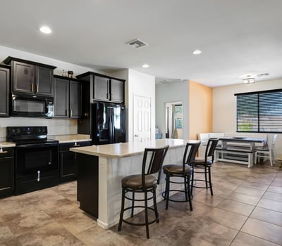 Kitchen view emphasizing dark cabinetry, coordinated appliances, and thoughtful layout designed for everyday use.