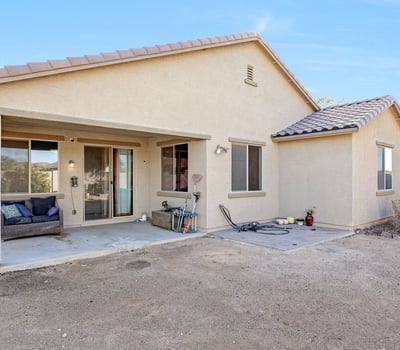 Covered patio providing shaded outdoor living space with room for seating and entertaining just steps from the interior.
