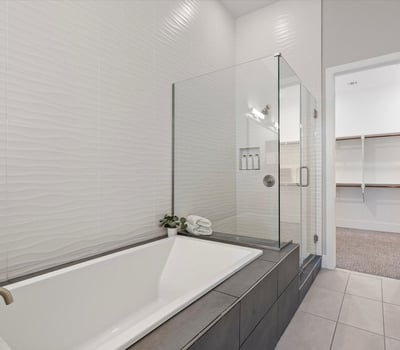 Luxury bathroom escape with soaking tub, glass-enclosed shower, and stylish tile accents for everyday indulgence.