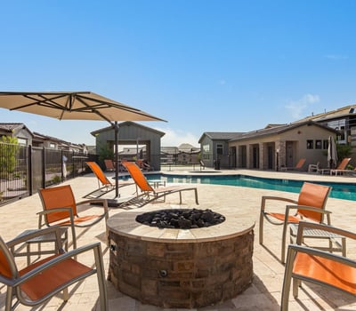 Stylish outdoor firepit lounge area with comfortable seating, creating a welcoming space for evening gatherings and relaxation.
