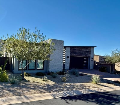 Front exterior highlighting contemporary architecture, desert landscaping, and clean modern lines in a prestigious Scottsdale neighborhood.
