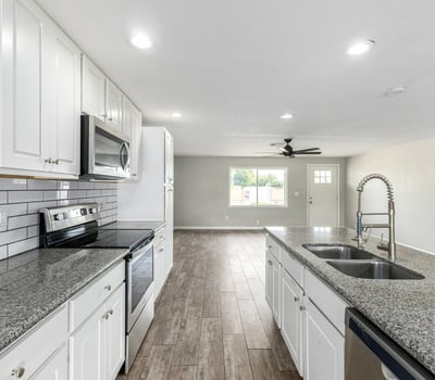 Detailed kitchen view showcasing granite countertops, stainless steel appliances, and modern cabinetry with subway tile backsplash an updated look buyers love in Phoenix real estate.