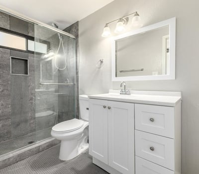 Updated bathroom featuring a walk-in shower with modern tilework, a fresh vanity, and clean finishes an excellent upgrade in this Phoenix home.