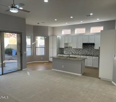Open kitchen and dining area with direct backyard access, recessed lighting, and updated finishes for seamless indoor-outdoor living.