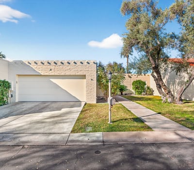 Well-maintained Phoenix exterior with attached garage, private walkway, and secure guard-gated access for peace of mind.