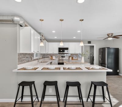 Large kitchen island with seating and pendant lighting, offering the perfect gathering space for hosting and daily use.