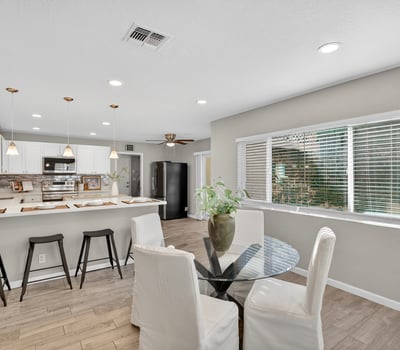 Dining area positioned between kitchen and living spaces, filled with natural light and ideal for both everyday meals and entertaining.