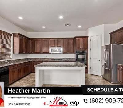 The large island and expansive granite surfaces provide ample workspace for cooking and entertaining. Rich cabinetry and built-in appliances enhance this Glendale property s appeal.