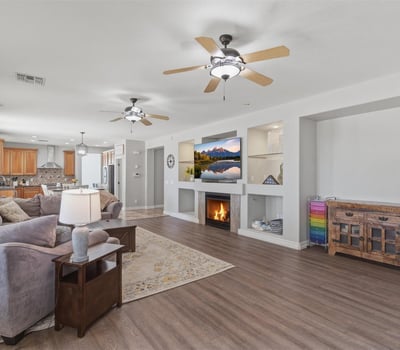 View of the large open living room connecting to the kitchen and dining areas, showcasing the modern floor plan designed for gatherings and everyday living.