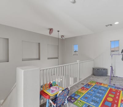 Large loft area overlooking the main entry, offering flexible space for a playroom, lounge, or second living room.