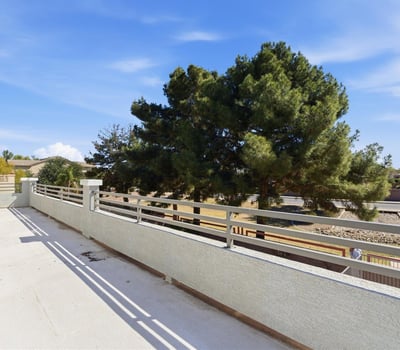Private balcony with open views of the backyard and surrounding greenery, offering a peaceful place to enjoy fresh air and morning coffee.