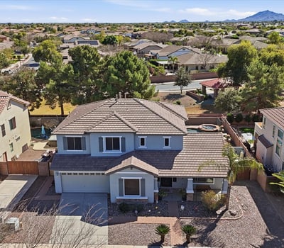 Aerial photo highlighting the full property footprint, landscaped yard, and surrounding neighborhood streets in this desirable Queen Creek location.