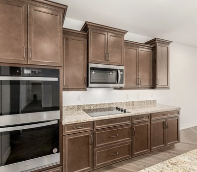 Gourmet kitchen featuring double ovens, sleek cabinetry, and premium finishes. Designed for convenience and elevated cooking experiences.