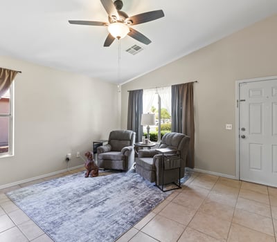 Bright and airy living room featuring large windows, neutral colors, and comfortable layout for everyday living.