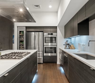 Stylish kitchen with integrated bar seating, quartz counters, and premium finishes, offering both function and elegance in this Phoenix property.