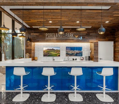 Chic bar lounge with wood accents, updated finishes, and seating for guests, perfect for socializing in Phoenix.