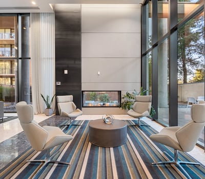 Inviting lounge area with a modern fireplace, plush seating, and elegant finishes, perfect for relaxing in Phoenix.
