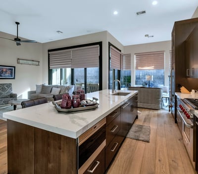 Open kitchen with oversized island, quartz surfaces, and seamless flow into the living area perfect for entertaining in this Phoenix home.
