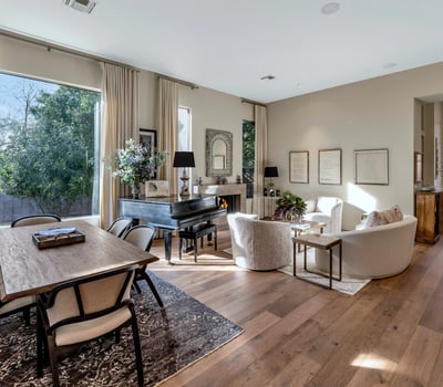 Flowing layout connecting dining and living spaces with modern finishes and warm wood flooring in this Phoenix property.