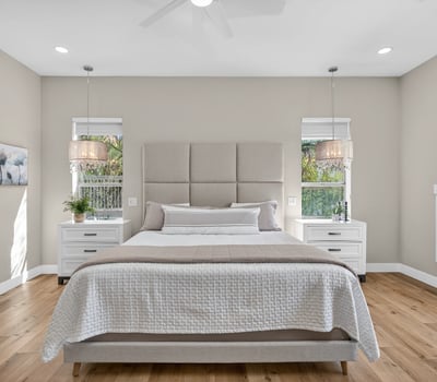 Stylish Scottsdale bedroom with abundant natural light, updated lighting fixtures, and neutral finishes for a calm, contemporary feel.