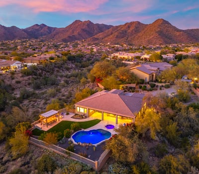 Scottsdale aerial view highlighting the backyard with pool, spa, and landscaped yard, offering privacy and desert surroundings.