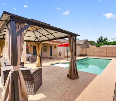 Backyard featuring a private pool and shaded pergola lounge area. Ideal for entertaining and enjoying warm Casa Grande evenings.