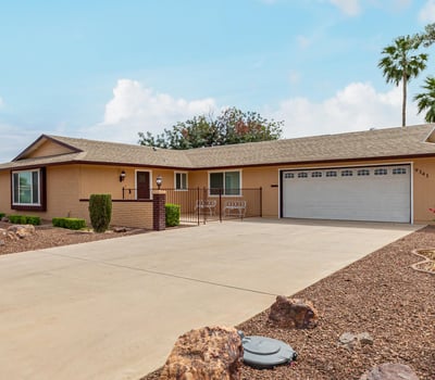 Clean exterior with attached two-car garage and extended driveway. This updated Sun City home provides convenience, storage, and modern upgrades.