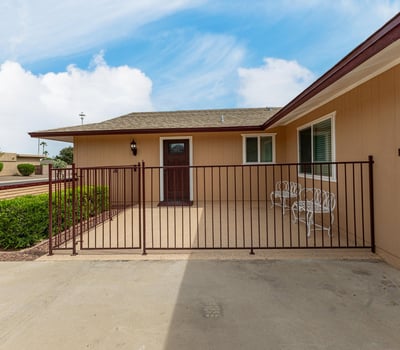 Secure front patio with gated entry, ideal for outdoor seating. This Sun City home features updated finishes and inviting outdoor spaces.