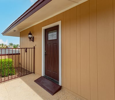 Close-up of upgraded front entry door with modern hardware. This Sun City home showcases thoughtful updates and welcoming design.