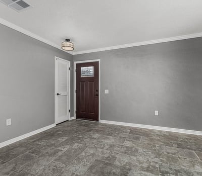 Entryway with sleek tile flooring, fresh paint, and updated lighting. This Sun City home offers a clean, contemporary interior feel.