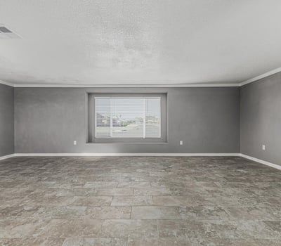 Light-filled living room with updated flooring and large window. This Sun City home offers a clean, modern feel with move-in ready convenience.