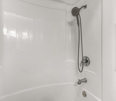 Clean bathroom featuring a tub and shower combo with modern fixtures. This Sun City home includes functional spaces and updated details.