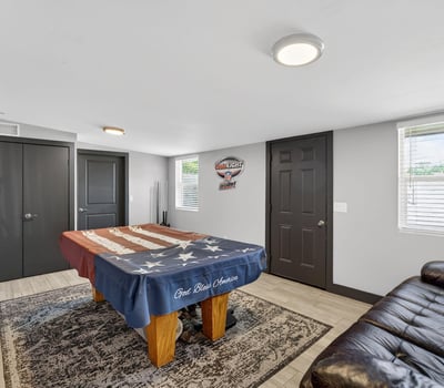 Large recreation room featuring a pool table and seating, offering a dedicated space for relaxation and entertainment.