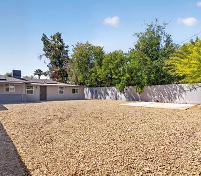 Generous backyard with gravel landscaping and open space, perfect for outdoor enjoyment and easy upkeep in this Phoenix property.